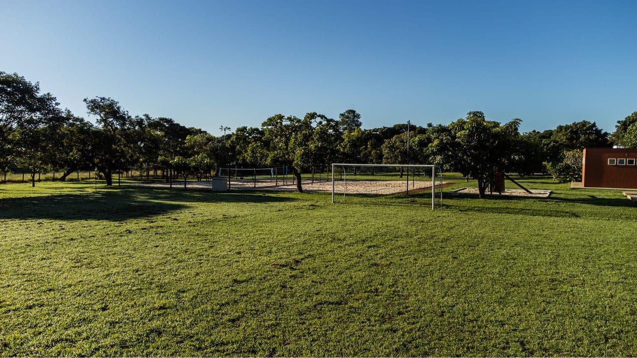 Grass field and sand courts in the background